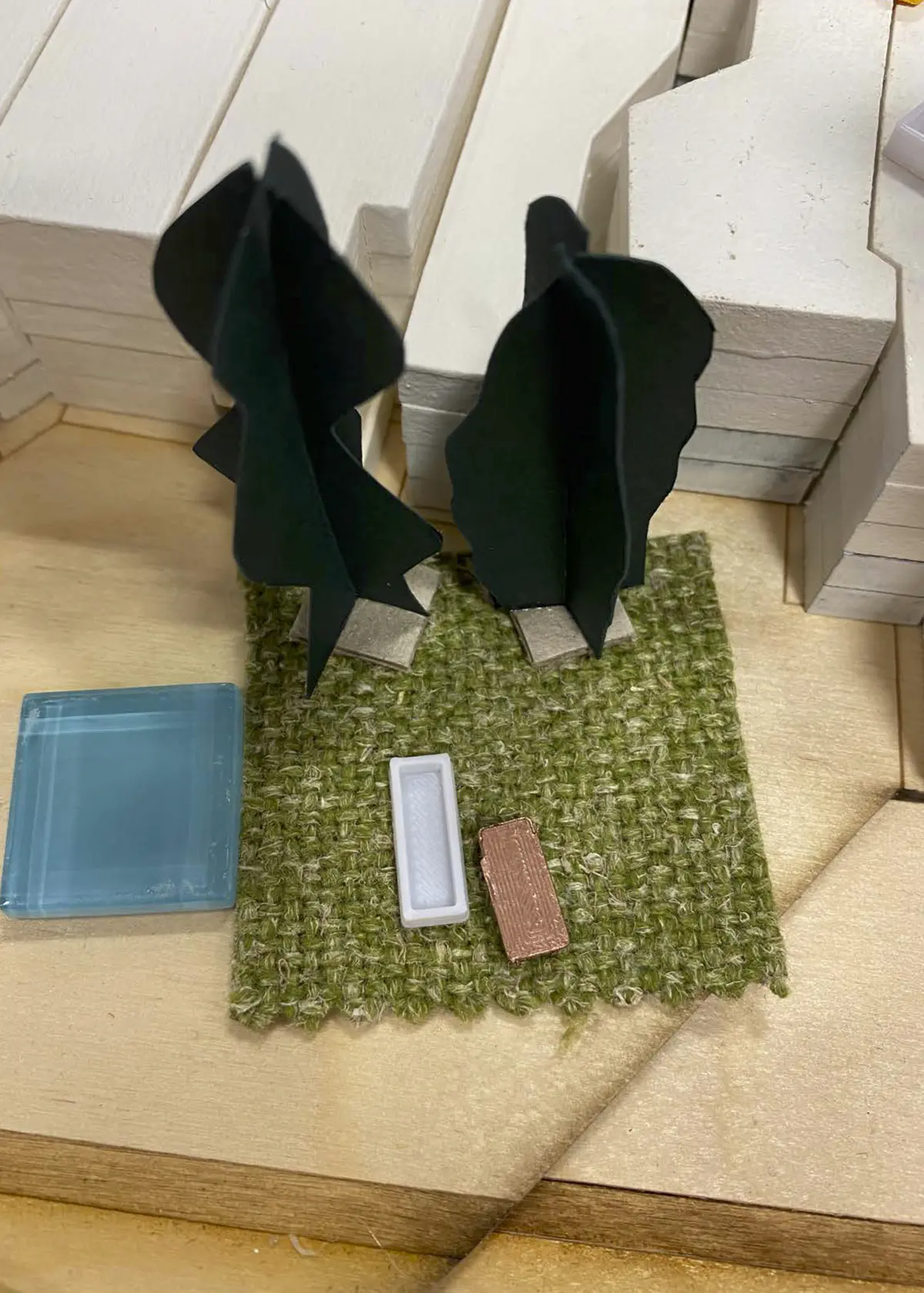 Looking to be the centrepiece of our exhibition, we proposed to create a site model of Dudley Highstreet at 1:200 scale with buildings modelled in a simple form. Local residents and visitors to the exhibition are then invited to decorate a chosen building to how they would envision it sat within the context of a greener Highstreet. We want to tie in our themes of biodiversity and materials by proposing that buildings can, and do, have the potential to be a lot healthier, sustainable, and interactive on the street. This site model also helps gain vital public opinions on the Highstreet and prompts discussion of areas most in need of attention.

To ensure that the model is utilising the MDF to the most efficient standard possible. First, the centres of the massing blocks have been hollowed out. This allows a reduction in materials used as other buildings can be cut in the centres of the model. Then the top is finished with a solid piece.
The waste material is placed into the recycling rack where other students can reuse it; otherwise, if the material left cannot be used for another project, it is recycled correctly by the university.

The model spanned just over 3.4m long and over 50cm wide. With the majority being cut from scrap woods that would fit the jigsaw of the shape, we were able to drastically cut down on waste. We also got some small benches and bee hives printed from recycled plastics, and used dried flowers as trees to represent the green spaces. Ultimately, the model seemed like a huge success, and really helped portray our ideas about Dudley High Street to those who came by. Everyone from Dudley who saw the model knew that it was the High Street, and interacted well with it. The size did make it difficult to move, especially to carry to the site, but it sat nicely in the centre of the the room and really drew people in to interact with it.

The model brought people in from outside to play with, write on, interact with. It became a spectacle for the public to come in and see what was happening and offer their ideas about what could be done.

The event was a success. Many people from the public (those who heard about the event, and those who just happened across it on the day) came in to interact with the model, which sat as the centre piece in the room. Kids liked to play with the pieces while the adults talked about things that could come from actions to help the High Street, not just leave it as is.

SOME OF THE KEY IDEAS WERE:
- The Shops need to be inviting for everyone. It’s no good having these places to go if people would rather take a bus to the next town.
- Just putting up boards across the windows is awful. Paint, Posters, Graffiti: Anything that actually makes the High Street look still alive is better than just wooden boards.
- More Green is needed. While it is obvious that there is a lack of Trees, many people wanted to push for these small bushes or planting spaces that could easily be implemented across the street.
- Spaces for public events or for people to at least gather at. While there is the Market and Fountain, it is not enough for the people of Dudley.
- Something needs to be done about the cars on the High Street. Some were Pro-Removal of all Cars, while some just wanted to limit when they could access the High Street.

Following the exhibition we created a series of drawings with our own interpretation of Sarah Wigglesworth ‘The Dining Table’ drawing. The drawings are a perfect representation of the our interactive model at the ERA Environmental Exhibition and Event. Showing the interaction the public had with the model, as well as the conversations that were held around the model. - Table 4.png